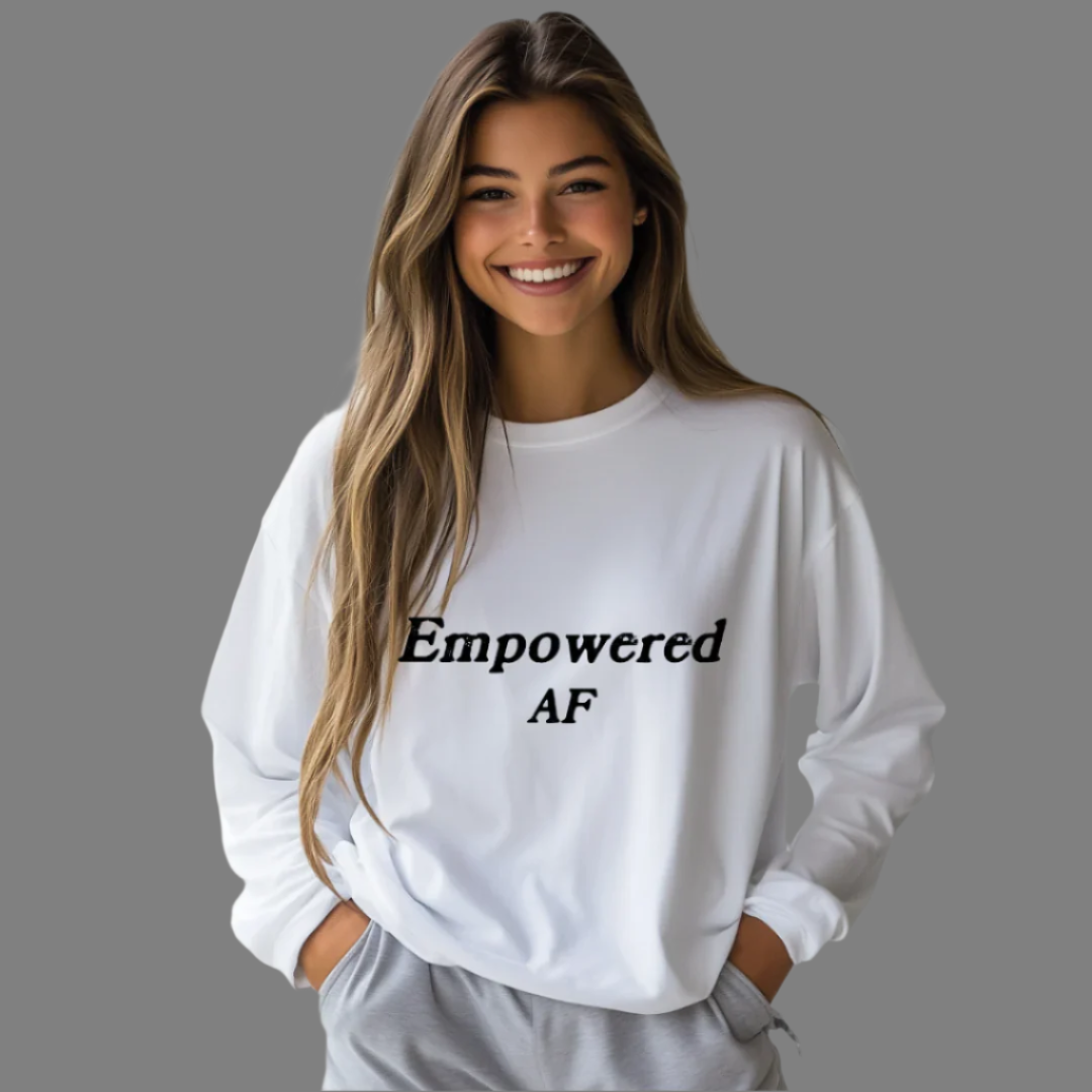 Model wearing a crew neck, long sleeve T-shirt with Empowered AF printed in block letters and centered on the chest.
Wear it, own it, live it