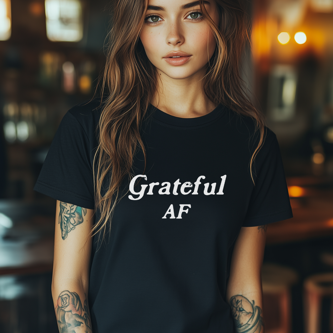 Model wearing a crew neck t-shirt with Grateful AF printed in block letters and centered on the chest.
Wear it, own it, live it.

