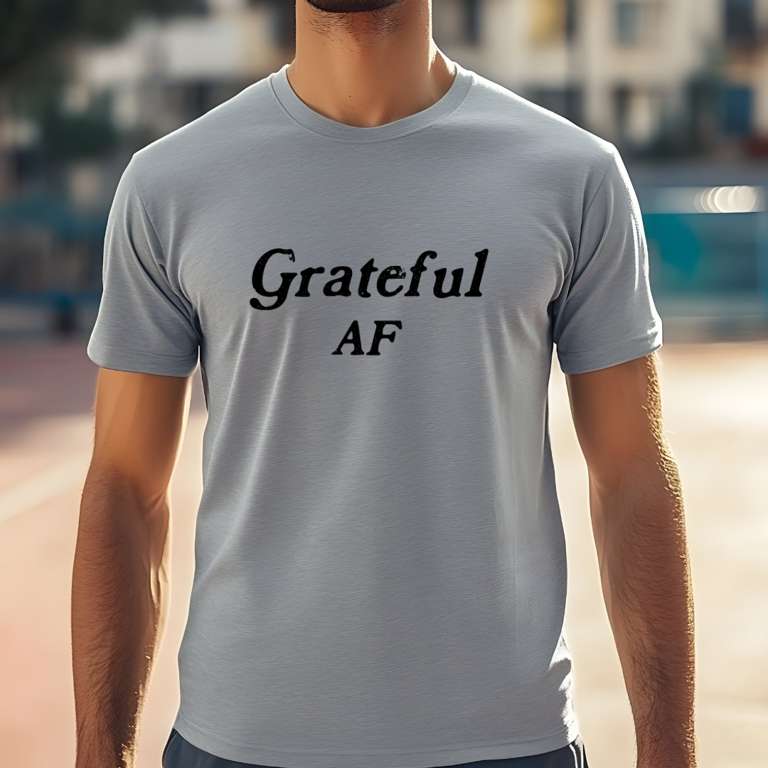 Model wearing a crew neck t-shirt with Grateful AF printed in block letters and centered on the chest.
Wear it, own it, live it.
