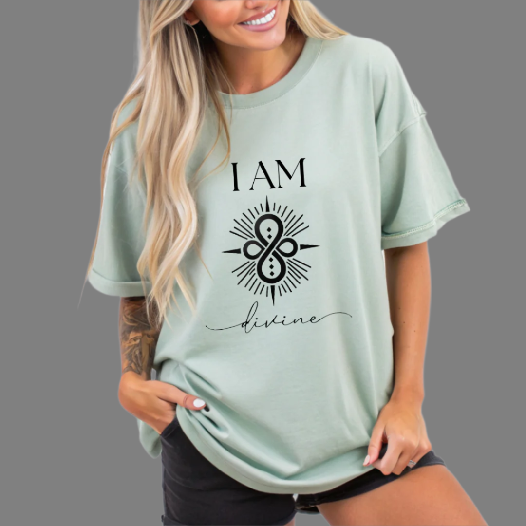 Model wearing a crew neck T-shit with symbolic sigil centered on the chest, representing divine.
The shirt reads 'I AM' in block font above the sigil and 'divine' in script font below the sigil.
Declare to the world: I AM divine.