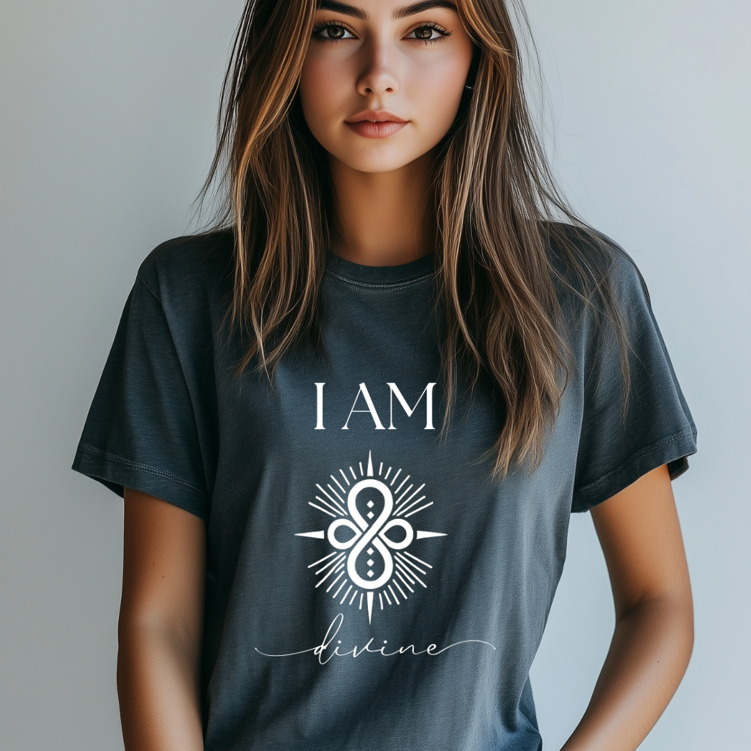 Model wearing a crew neck T-shit with symbolic sigil centered on the chest, representing divine.
The shirt reads 'I AM' in block font above the sigil and 'divine' in script font below the sigil.
Declare to the world: I AM divine.