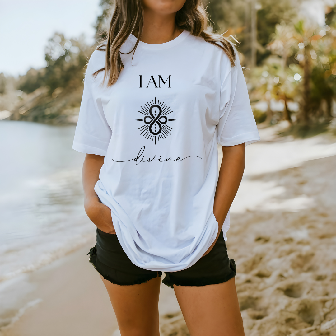 Model wearing a crew neck T-shit with symbolic sigil centered on the chest, representing divine.
The shirt reads 'I AM' in block font above the sigil and 'divine' in script font below the sigil.
Declare to the world: I AM divine.