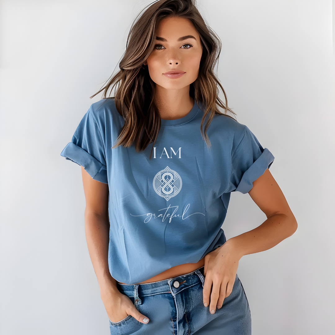 Model wearing a crew neck t-shirt,  with symbolic sigil centered on the chest, representing grateful.
The shirt reads 'I AM' in block font above the sigil and 'grateful' in script font below the sigil.
Declare to the world: I AM grateful.