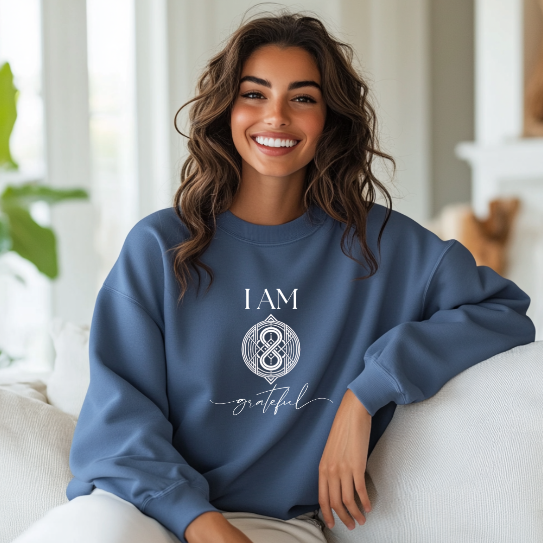 Model wearing a crew neck sweatshirt with symbolic sigil centered on the chest, representing grateful.
The shirt reads 'I AM' in block font above the sigil and 'grateful' in script font below the sigil.
Declare to the world: I AM grateful.
