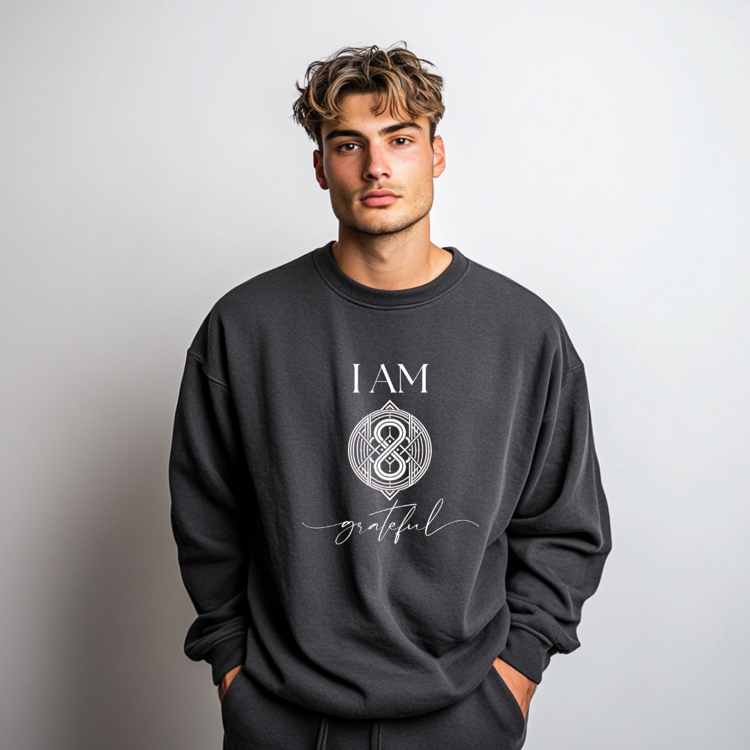 Model wearing a crew neck sweatshirt with symbolic sigil centered on the chest, representing grateful.
The shirt reads 'I AM' in block font above the sigil and 'grateful' in script font below the sigil.
Declare to the world: I AM grateful.