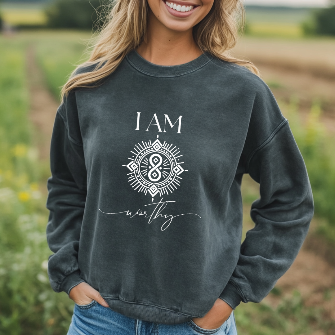 Model wearing a crew neck sweatshirt with symbolic sigil centered on the chest, representing worthy.
The shirt reads 'I AM' in block font above the sigil and 'worthy' in script font below the sigil.
Declare to the world: I AM worthy.