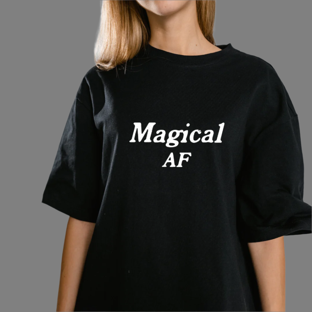 Model wearing a crew neck t-shirt with Magical AF printed in block letters and centered on the chest.
Wear it, own it, live it.