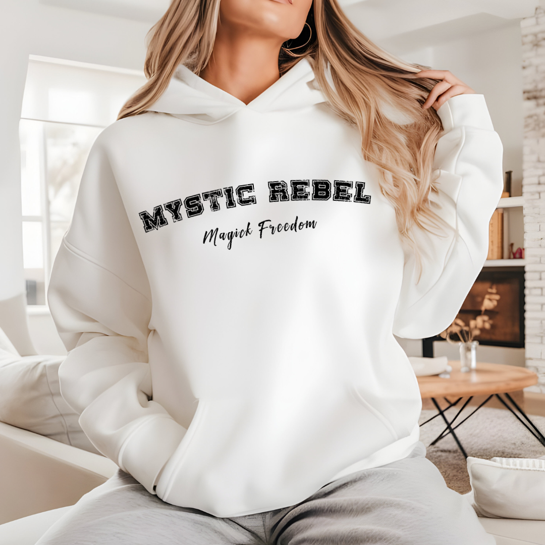 Model wearing a hoodie that reads Mystic Rebel in university font, arched across the chest with Magick Freedom in scripted font below.
Unleash your wild, untamed spirit!
