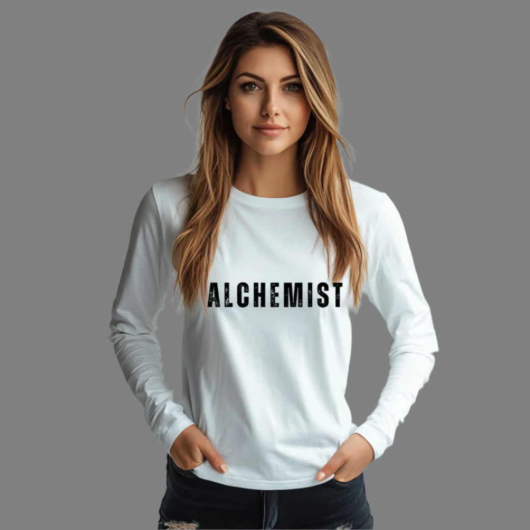 Model wearing crew neck long sleeve T-shirt that reads ALCHEMIST in distressed block letters across the chest. "Turning Everything Into Love" in two lines of smaller block letters is written on the back.
Embody love in all things.