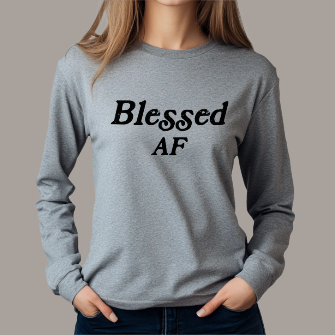 Model wearing a crew neck, long sleeve T-shirt with Blessed AF printed in block letters and centered on the chest.
Wear it, own it, live it.