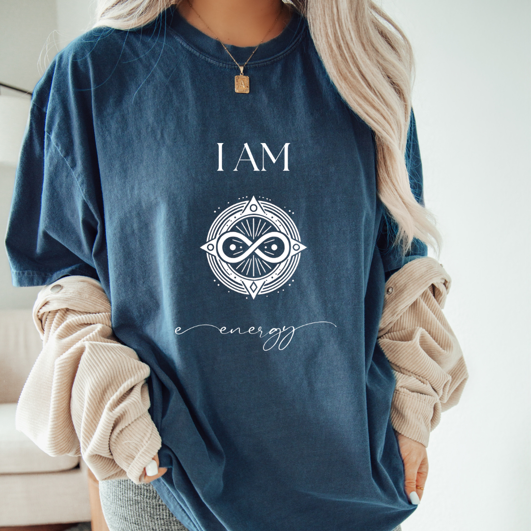 Model wearing a crew neck t-shirt,  with symbolic sigil centered on the chest, representing energy.
The shirt reads 'I AM' in block font above the sigil and 'energy' in script font below the sigil.
Declare to the world: I AM energy.