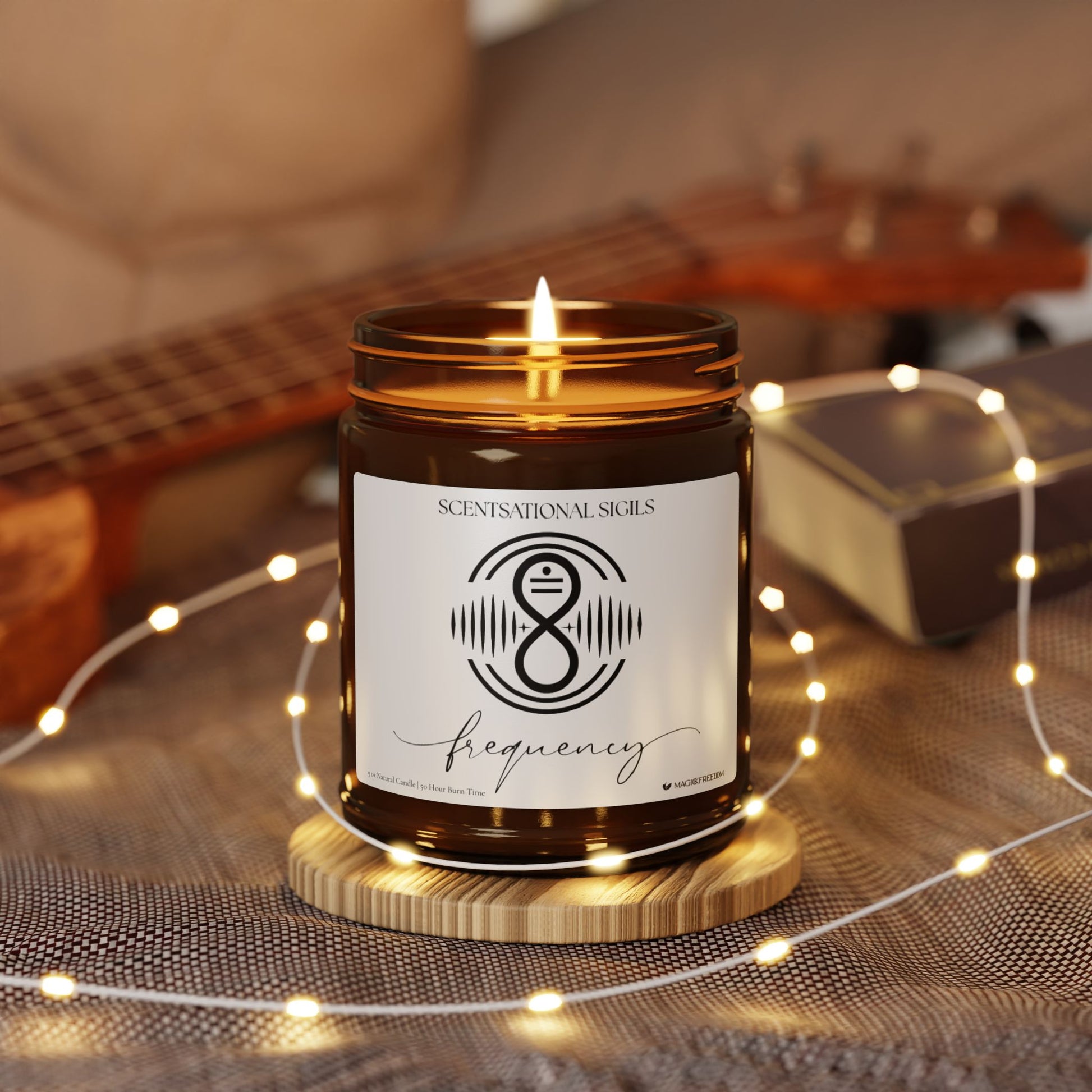 Amber glass intention candle featuring the Frequency sigil symbol with ‘frequency’ written in script underneath, displayed on an altar with sacred items