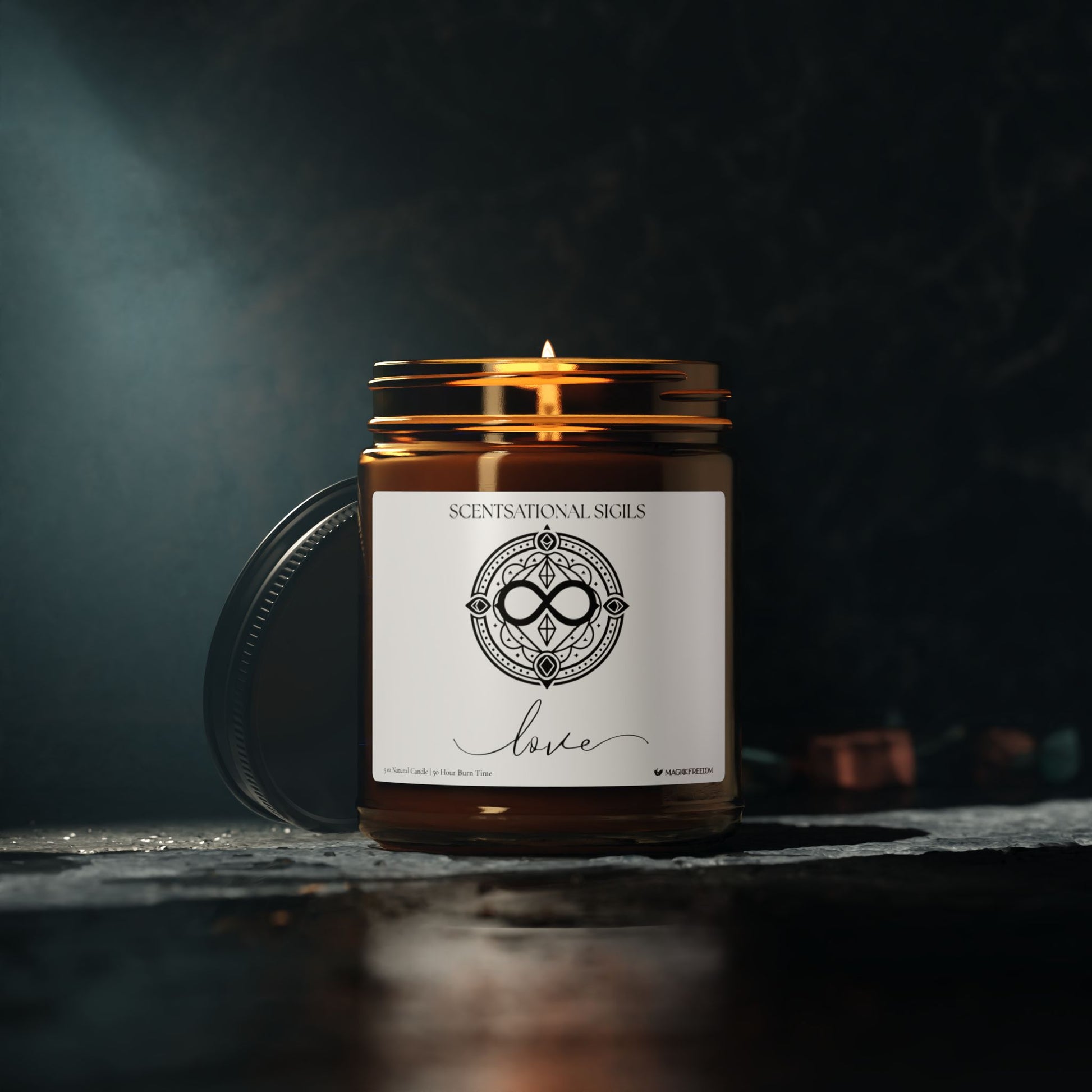Amber glass intention candle featuring the Love sigil symbol with ‘love’ written in script underneath, displayed in a dark mystical setting.