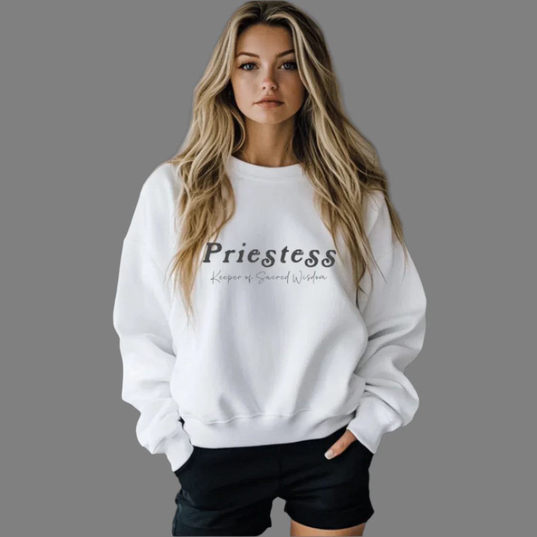 Model wearing a crew neck sweatshirt.
The sweatshirt says “Priestess” in distressed lettering across the chest with “Keeper of Sacred Wisdom” printed in smaller scripted lettering underneath.
Wear, Embody, Be the Priestess.