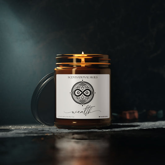 Amber glass intention candle featuring the Wealth sigil symbol with ‘wealth’ written in script underneath, displayed in a dark mystical setting